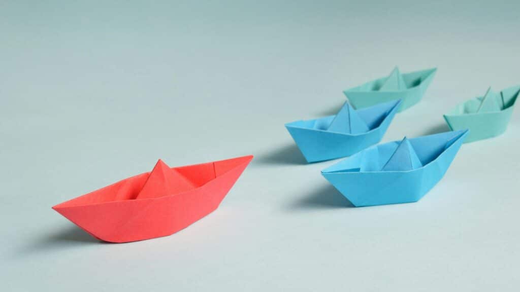 Paper boats promoting reflection; Dr Kim Burns Higher Ed Coach and Consultant for women in leadership
